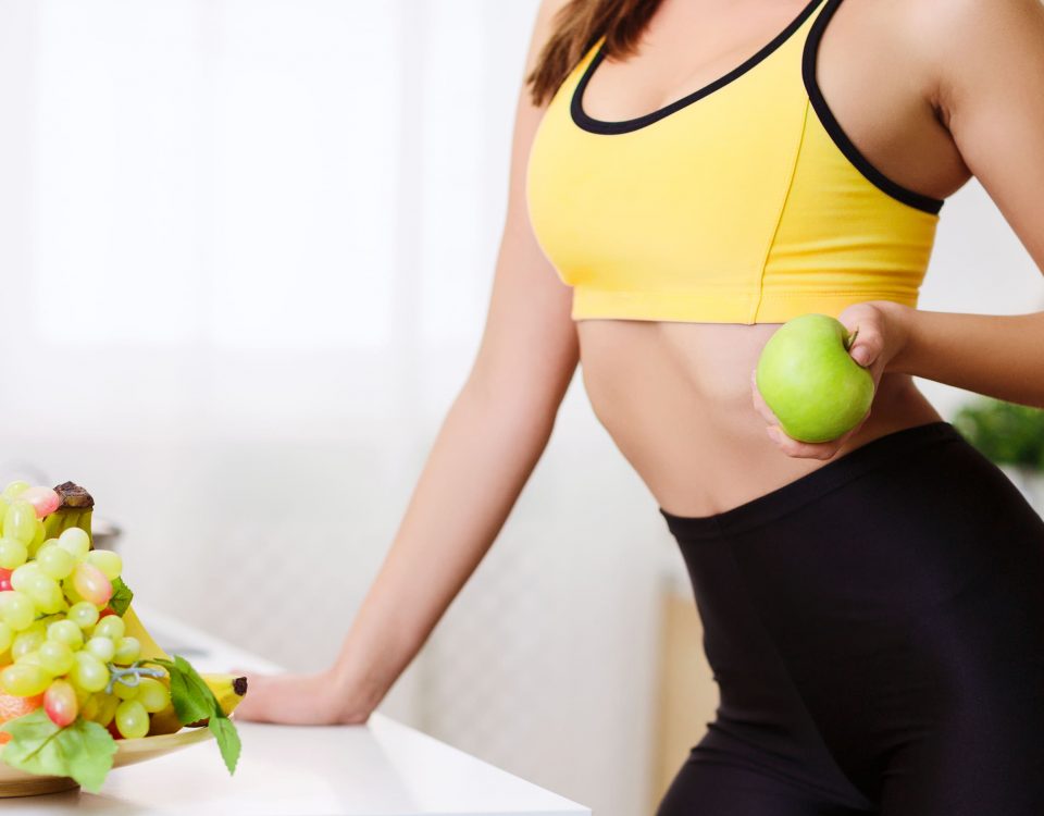 imagen de una mujer con fruta y una manzana en la mano